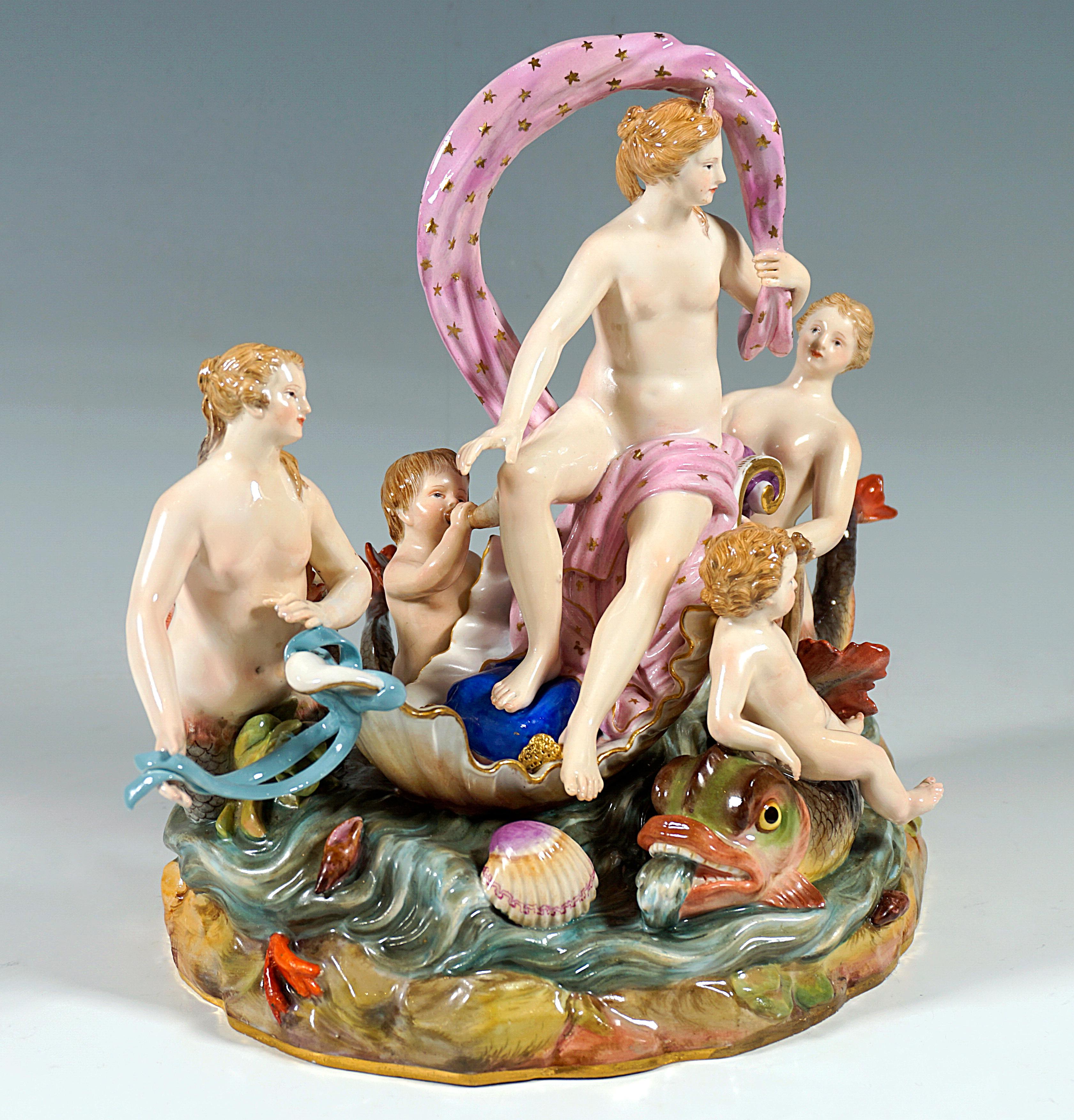 Excellent Meissen porcelain group of the 19th century:
Nymph, covered only with a cloth, seated on a half shell floating on the water, holding the cloth at one end so that it forms a wavy noose over her body, accompanied by three sirens, two girls