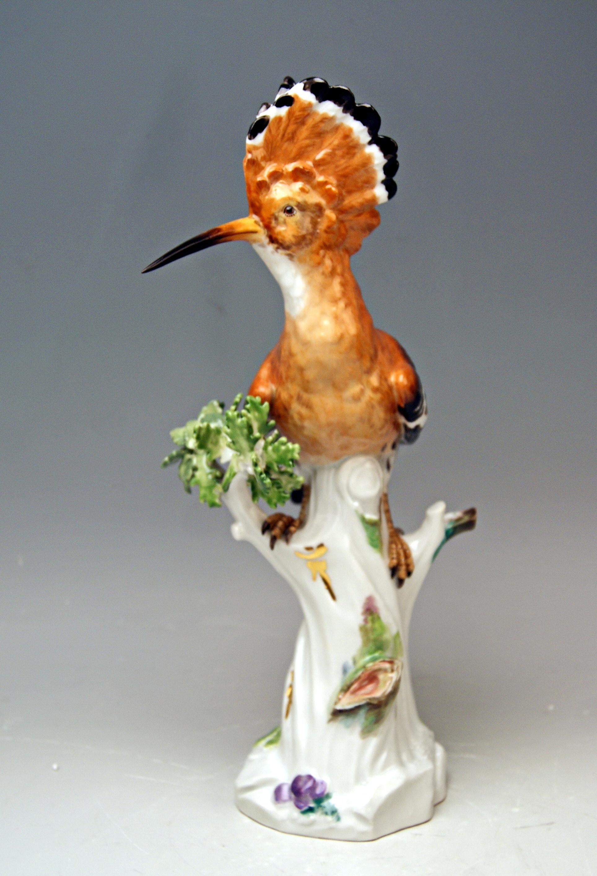 Animal Figurine: Hoopoe situated on a tree's stump 

Manufactory: Meissen
Hallmarked: Blue Meissen Sword Mark With Pommels on Hilts (underglazed)
model number 278 / former's number 35
First quality
Dating: made circa 1850
Material: porcelain,