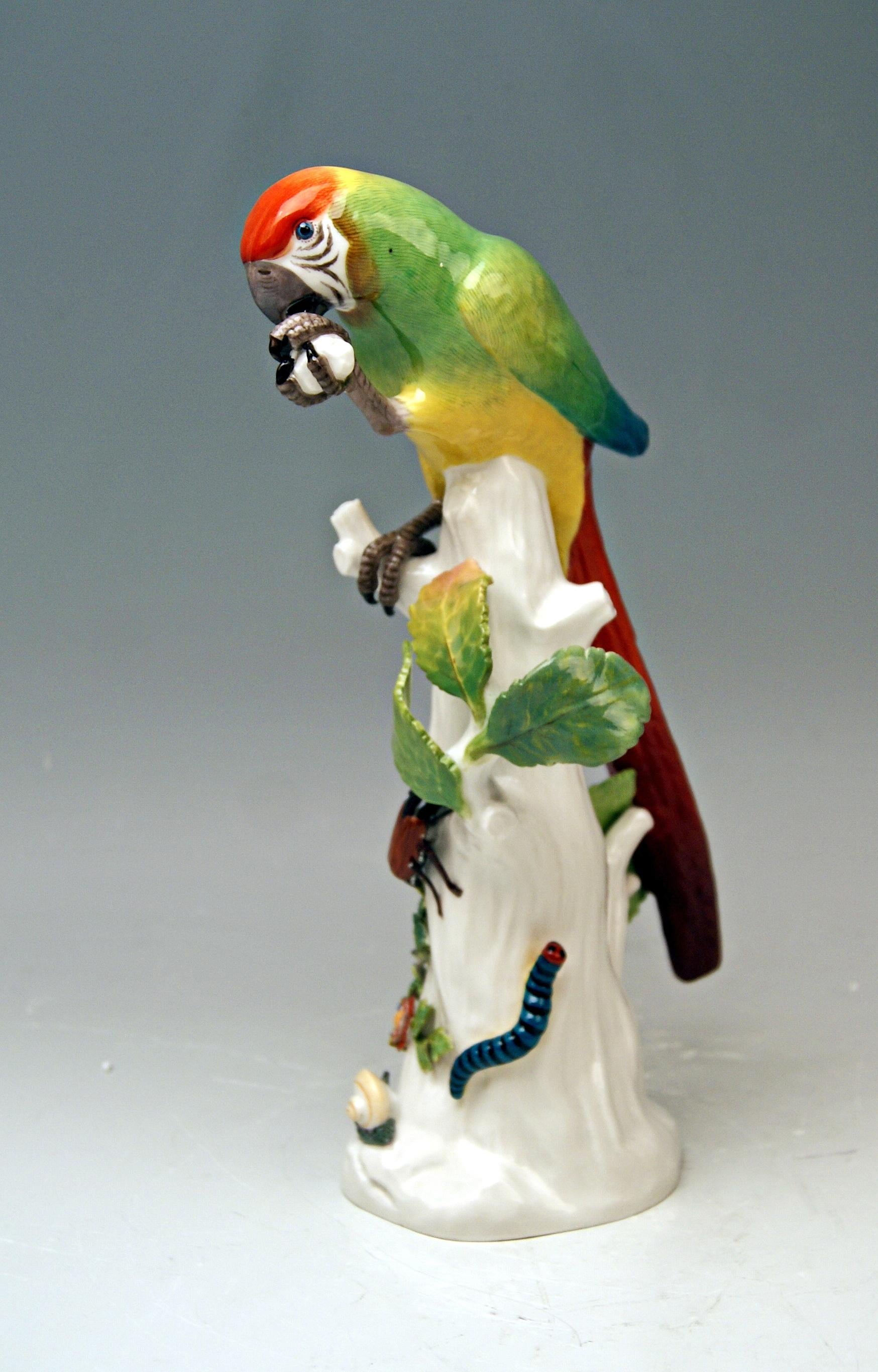 Animal figurine: Parrot situated on a tree's stump with cockchafer

Manufactory: Meissen
Hallmarked: 
Blue Meissen Sword Mark With Pommels on Hilts (underglazed)
model number 20x / painter's number 21 / former's number 13
First