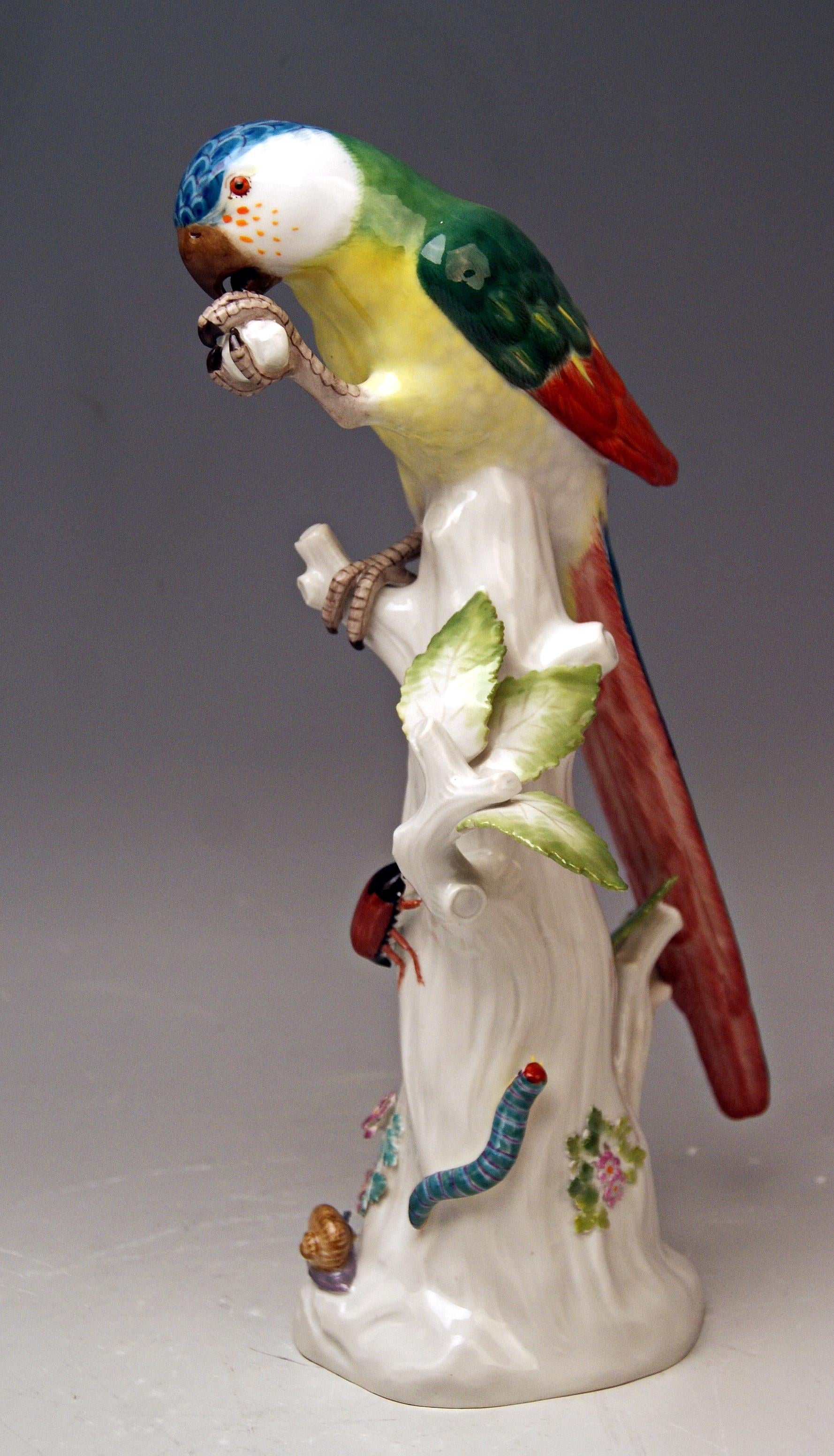 Animal Figurine:  Parrot situated on a tree's stump with cockchafer

Manufactory: Meissen
Hallmarked:  
Blue Meissen Sword Mark of 20th century  (underglazed)
model number 20x  /  former's number 104
FIRST QUALITY    
Dating:    made 1956   (year's