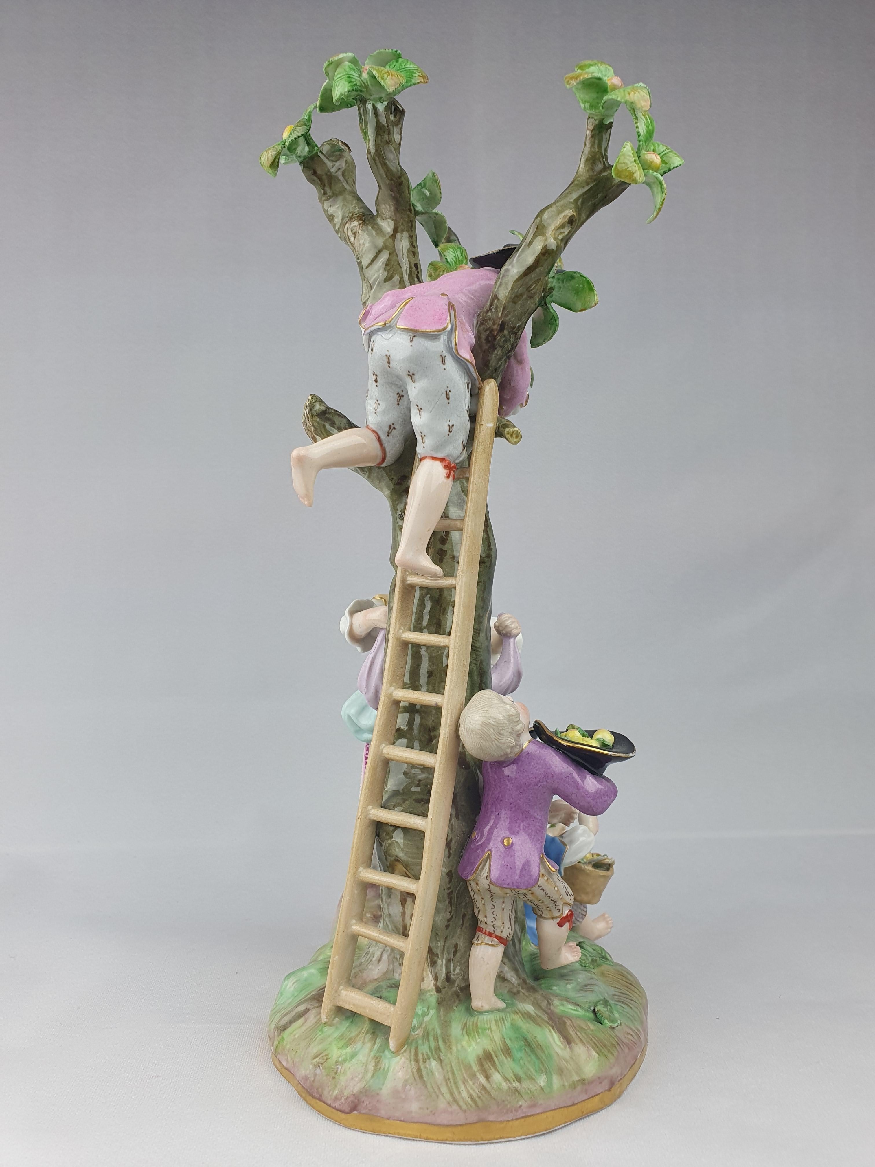Meissen Porcelain Figure group of Apple Pickers late 19th Century after a model by J.J. Kaendler and F.E. Meyer of 1751 depicted as a maiden and three young boys climbing a ladder and gathering fruit from an apple tree.

Underglaze blue crossed