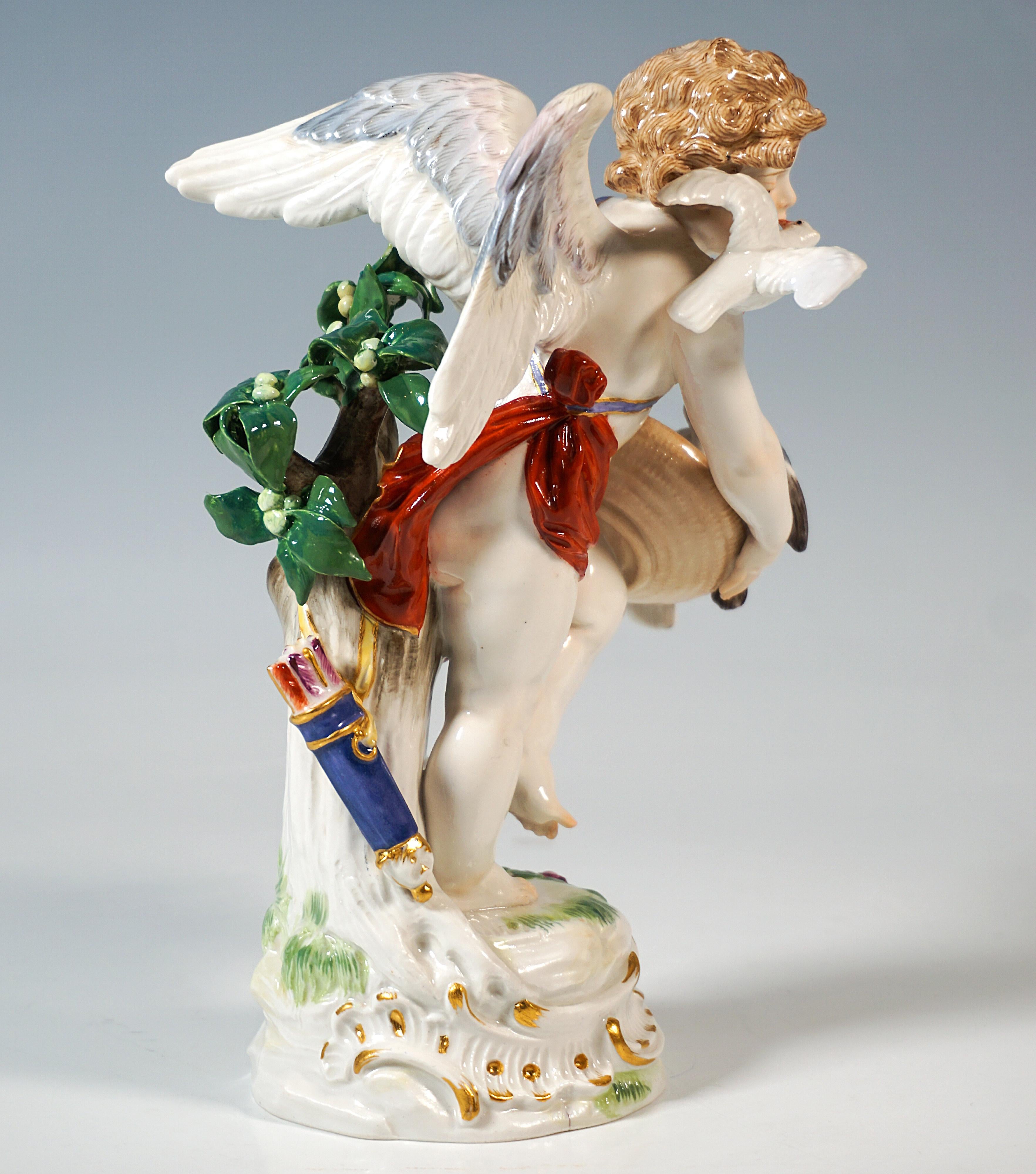 Excellent Art Nouveau porcelain figurine by Paul Helmig:
A winged cupid boy, covering his nakedness with a loose cloth, leaning backwards against a tree trunk with foliage and a quiver of love arrows slung over, holding a large basket with both