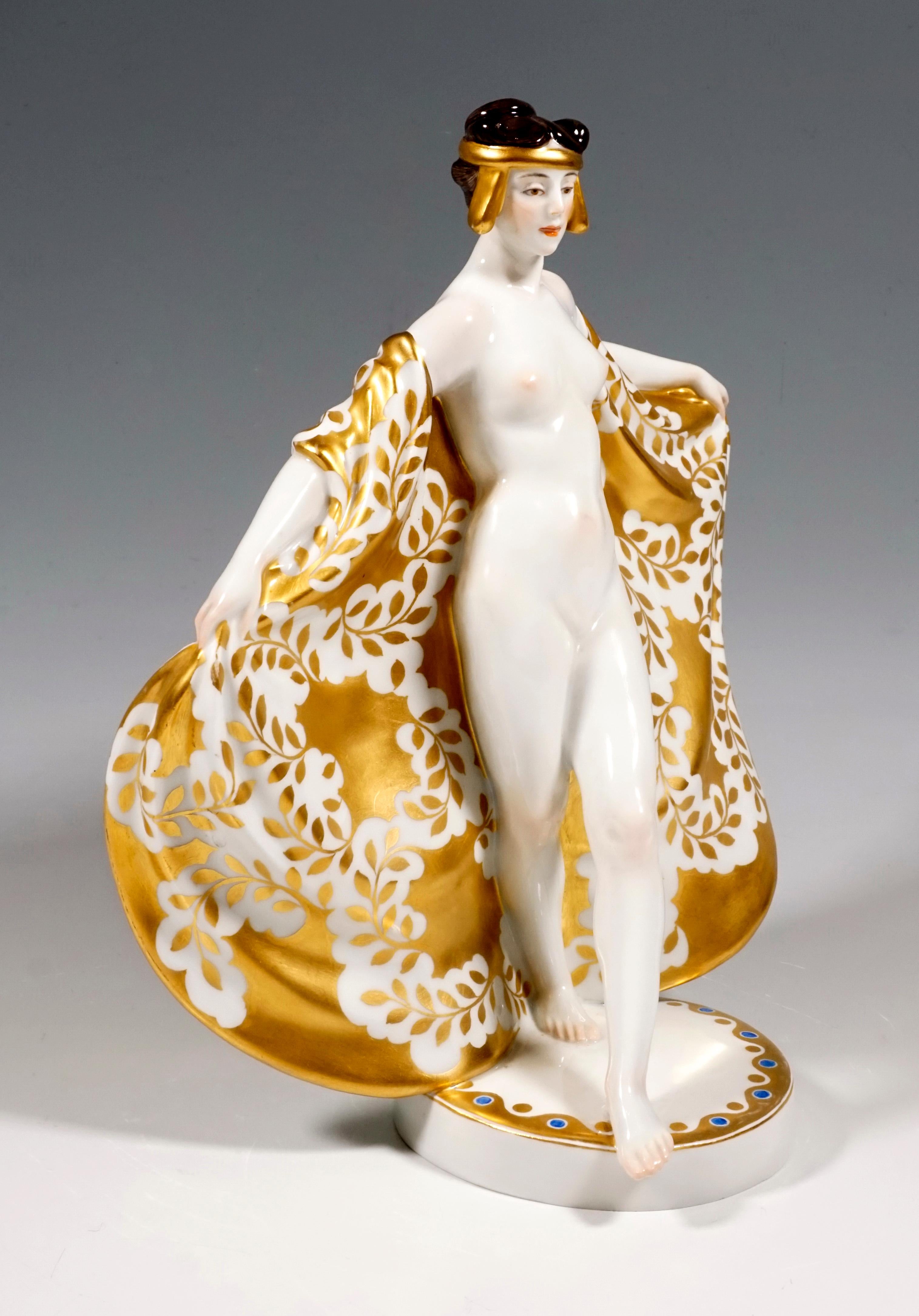 Extremely decorative, sculptural representation of the dancer Loie Fuller, undressed, just wearing a large, softly falling, floor-length cloth with a golden laurel branch decoration around her shoulders. She wears a golden, oriental-looking