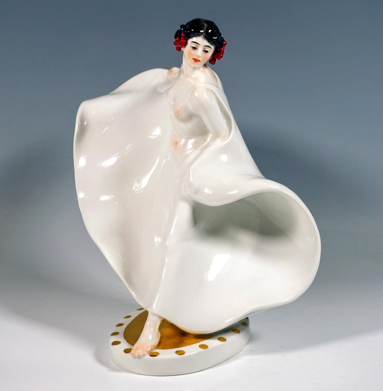 Extremely decorative, fully sculpted depiction of the dancer Loie Fuller, undressed, merely wearing a large, softly falling, floor-length white cloth around her shoulders and letting it swing around her in a swaying movement, red pearl jewelry in