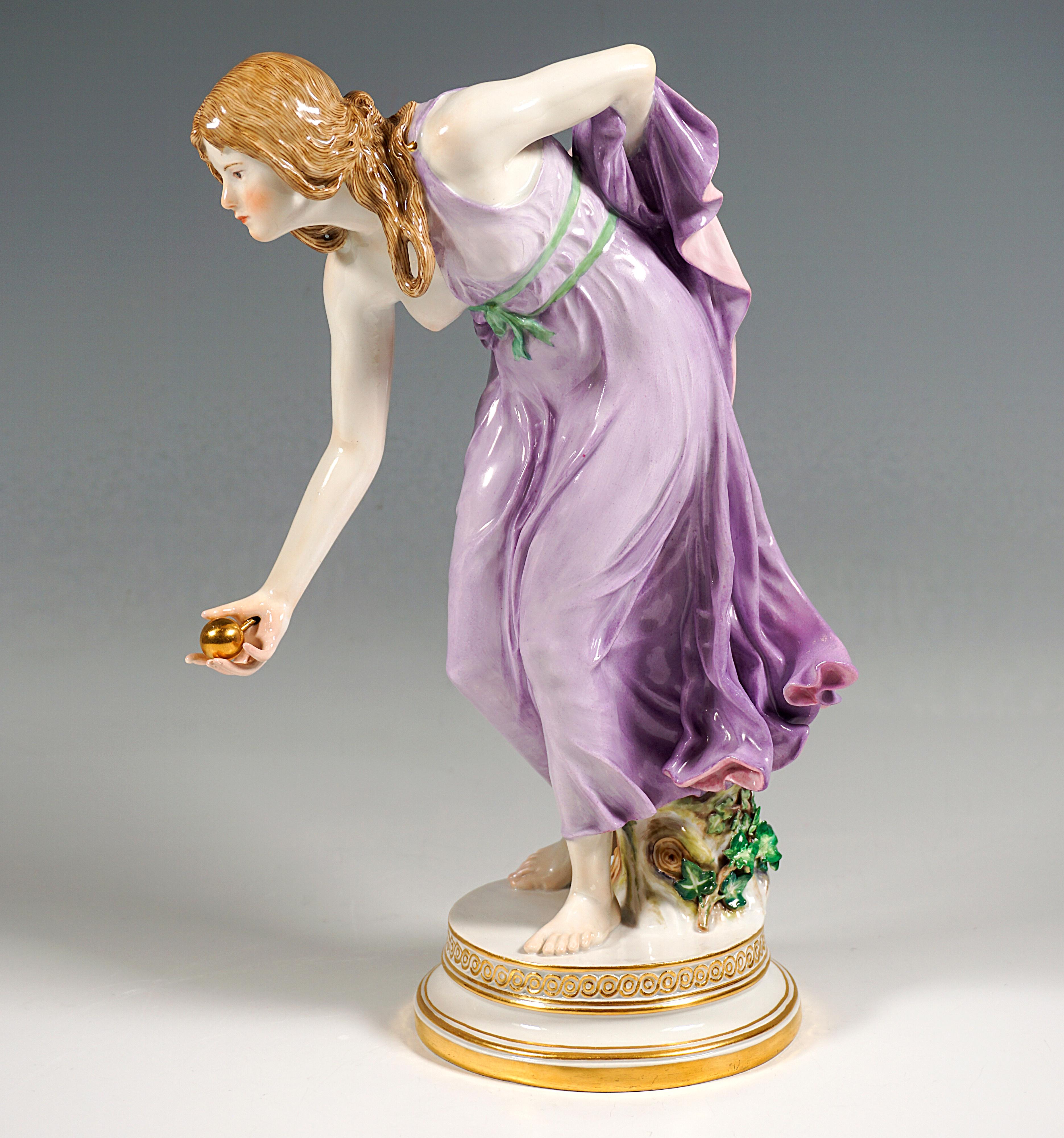 Extremely decorative, fully sculptural representation of an Art Nouveau beauty in a softly falling robe, tilted forward to throw a golden ball, with the left forearm holding the back hem of the dress on her back.
The figure is supported by a tree