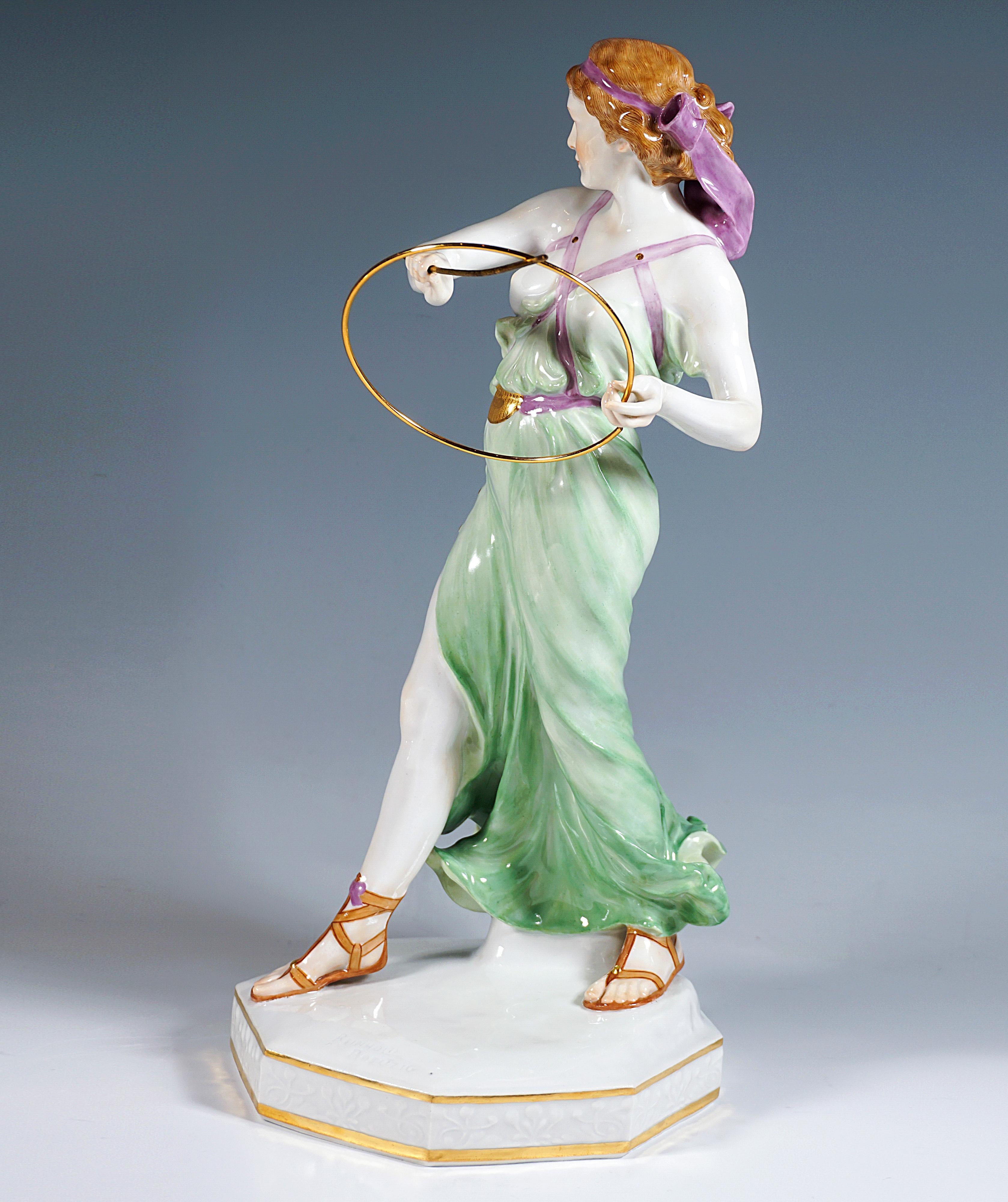 Extremely decorative full-sculptural representation of an Art Nouveau beauty in softly falling robe held together by straps on the upper part of the body with partially exposed chest, in graceful striding pose, the upper part of the body slightly