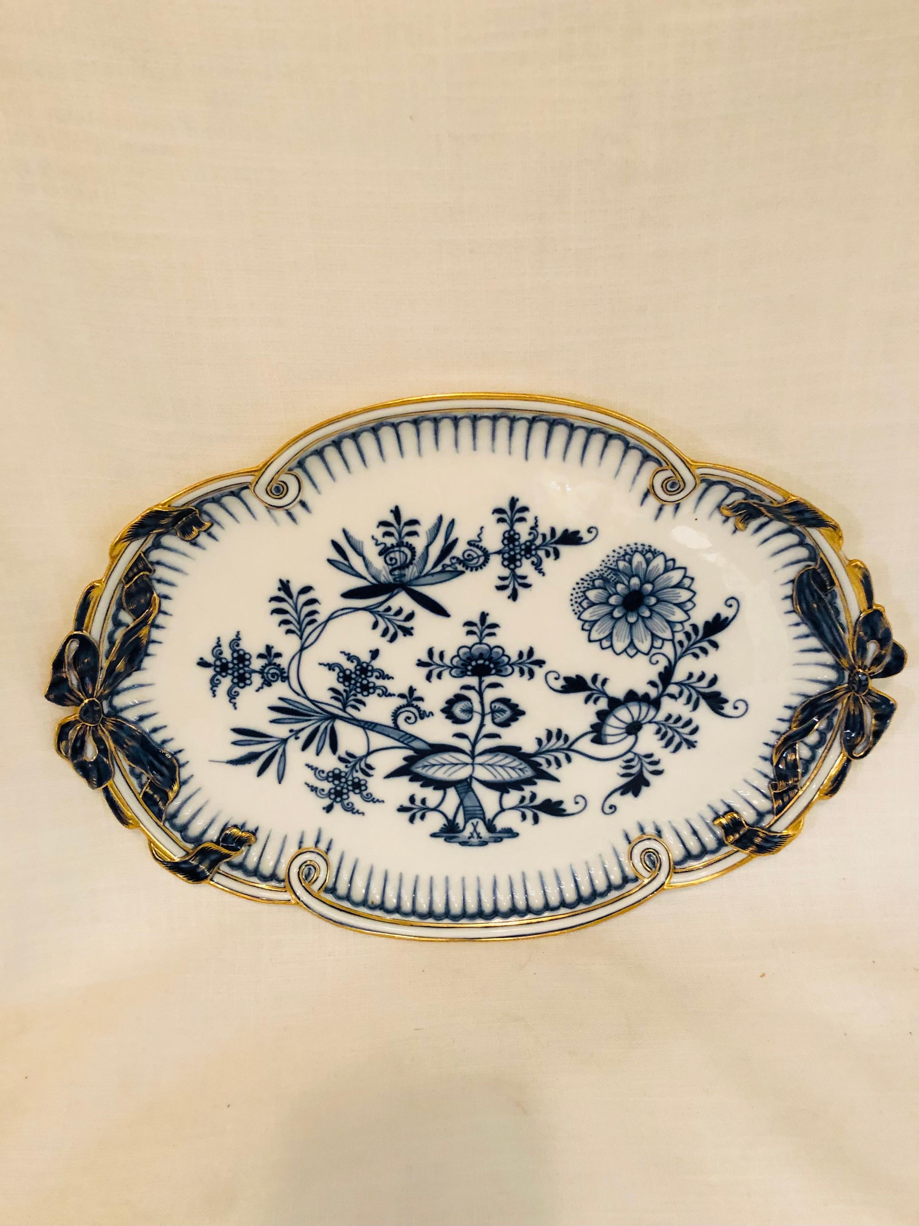 This is a stunning Meissen blue onion serving tray with a gold border and handles in the shape of bows. It is 16 by 11.5 inches. It would be a perfect tray to serve petits fours, tea sandwiches, cookies or pastries. It would also be a perfect tray