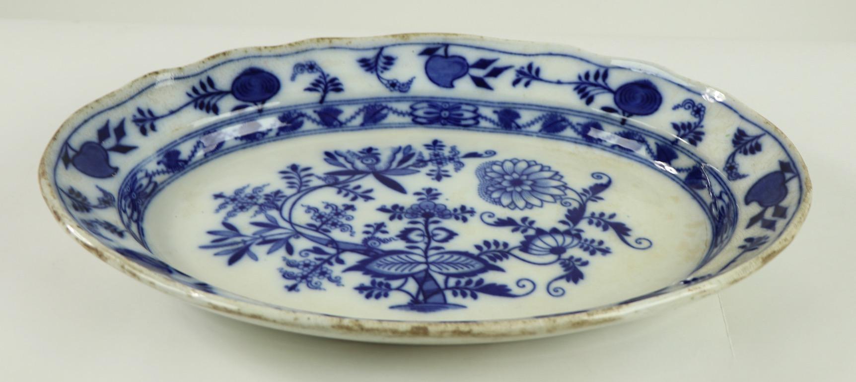 Charming 19th century oval serving platter by Meissen, England in the blue onion pattern. The platter is in good condition, free of chips or cracks, it does show staining and discoloration along the edge, as shown.