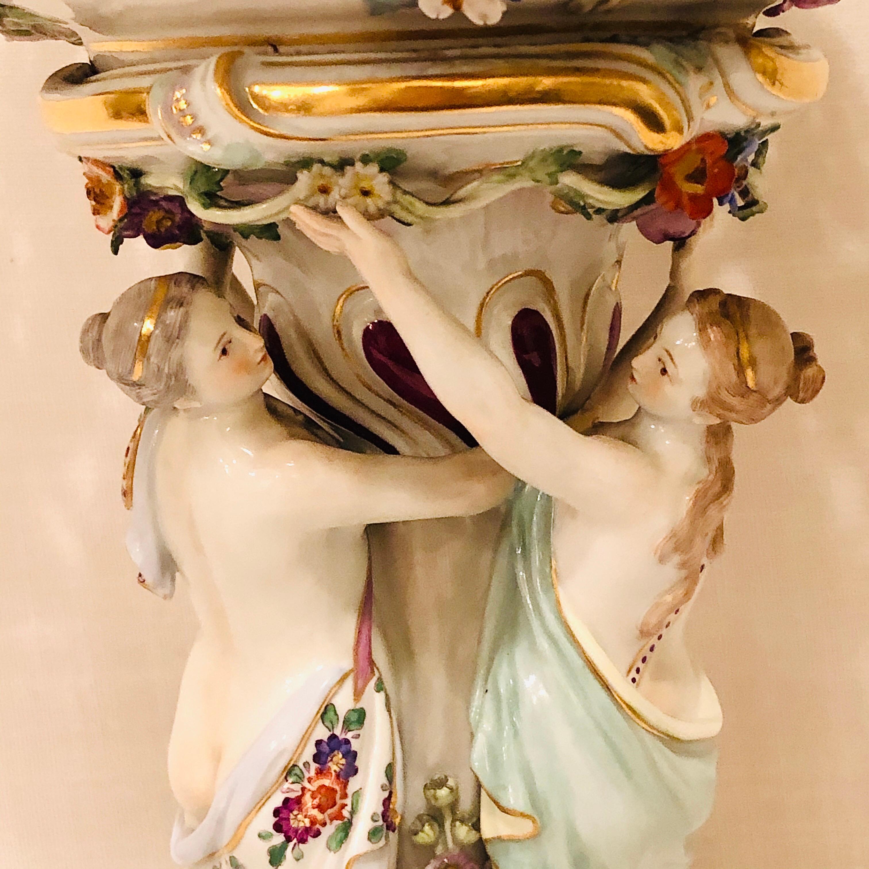 Meissen centerpiece of the three graces or charities dancing in a circle. These three graces are from Greek mythology and they represent charm, beauty, nature, good will, fertility and human creativity. These beautiful ladies are eternally young and
