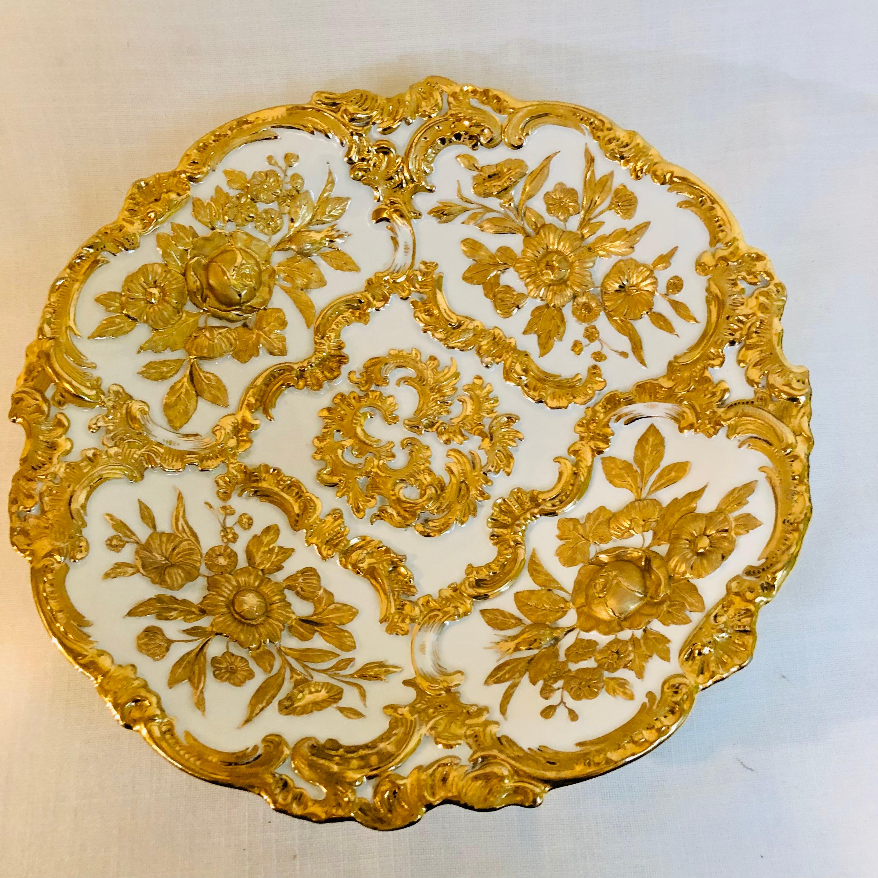 This is an absolutely gorgeous Meissen gold and white charger or round platter. It has a beautiful raised gold decoration of flowers and leaves with other elaborate gilded accents. If you look at the attached photographs, you can see the profuse