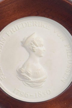 Meissen. Circular relief plaque in biscuit with female profile portrait. 1970s