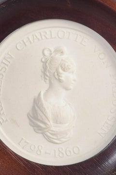 Meissen. Circular relief plaque in biscuit with female profile portrait. 1970s