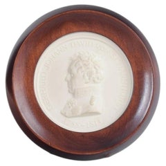 Meissen. Circular relief plaque in biscuit with male profile portrait. 1970s