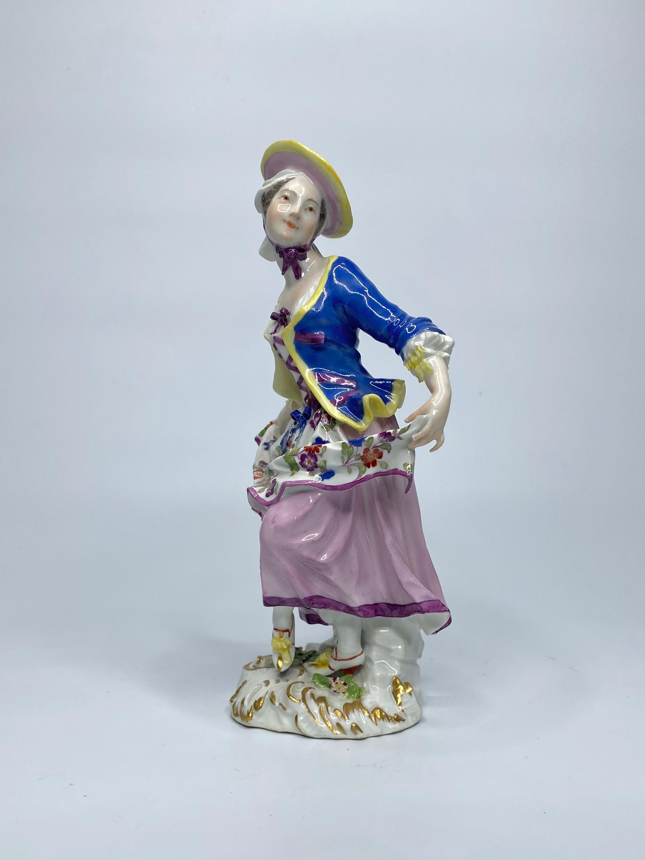 Meissen porcelain figure, ‘Cris de Paris’ series, circa  1755. Finely modelled by Johann Joachim Kändler, as the ‘Bakers Companion’ – the young dancing girl, dressed in 18th century costume, holding the hems of her ‘Indianische Blumen’ decorated