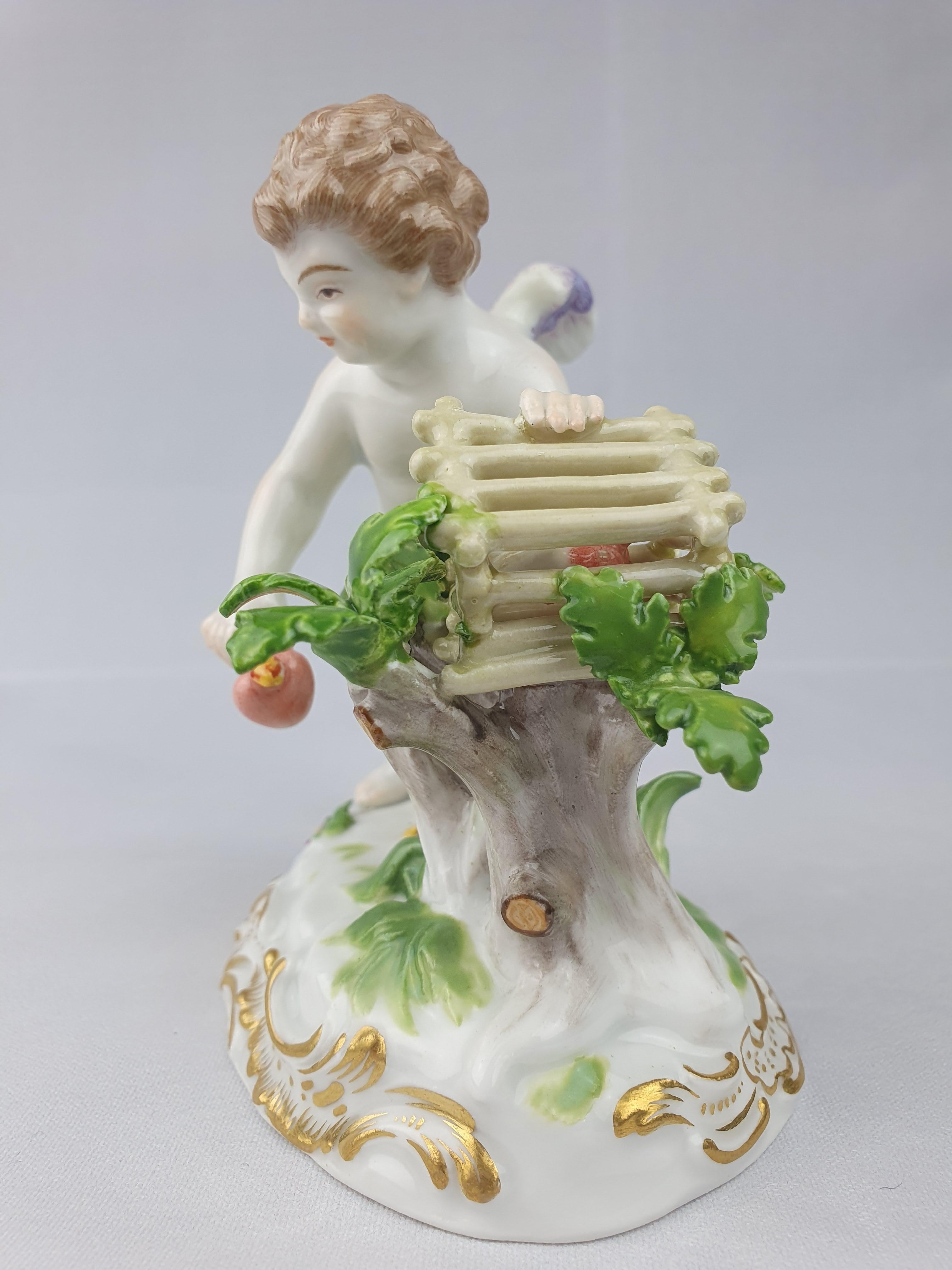 Meissen figure of cupid with flaming heart in wooden cage. Cross swords in underglaze blue. Incised model number O186.

circa 1890.

Height is 11.5cm.