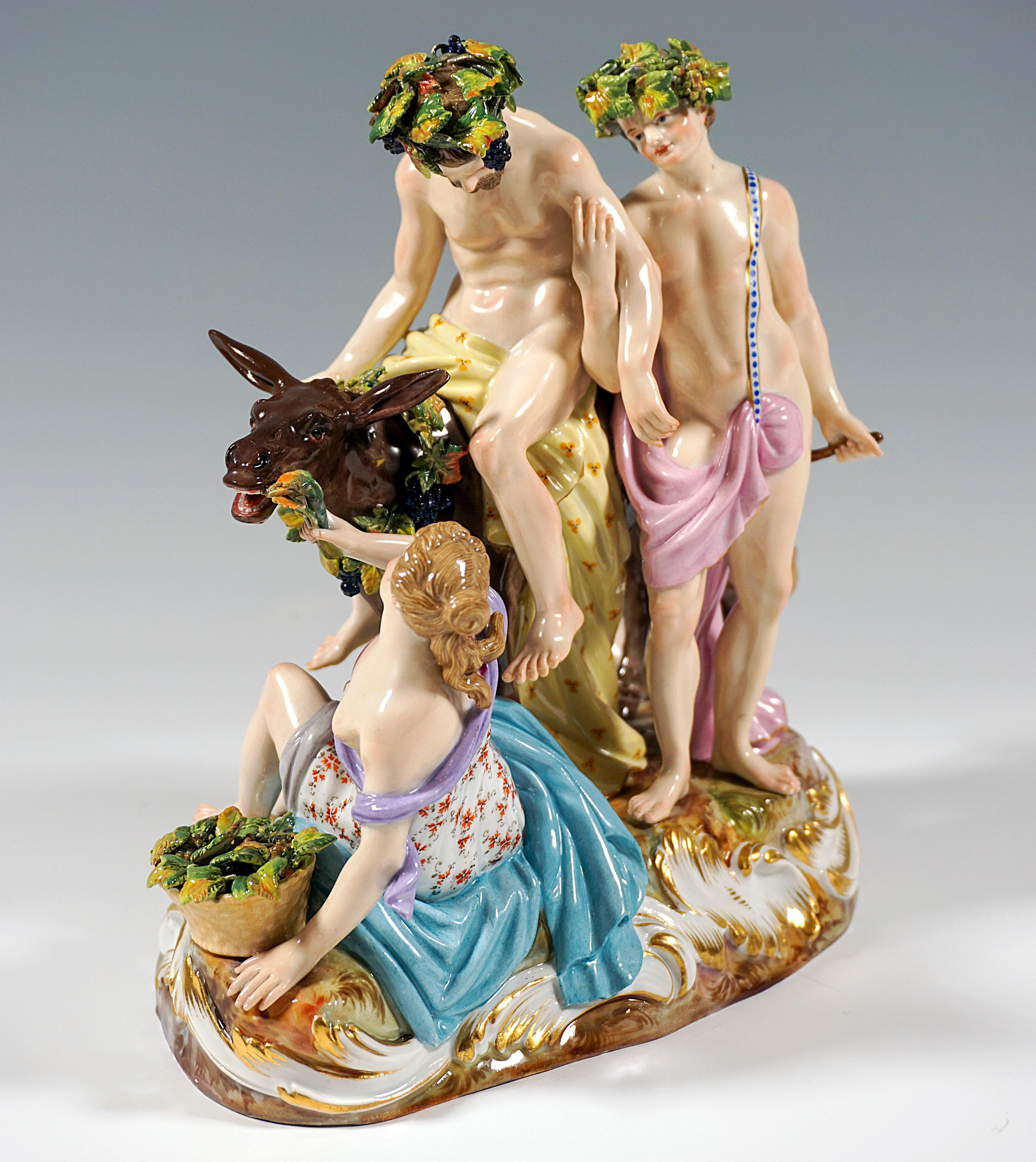 Extraordinary porcelain figure group from the 19th century:
Obviously drunken Silen, crowned with a wreath of grapevines, sitting on a donkey and supported by a young bacchante striding sideways beside him so that he cannot fall off, in front of