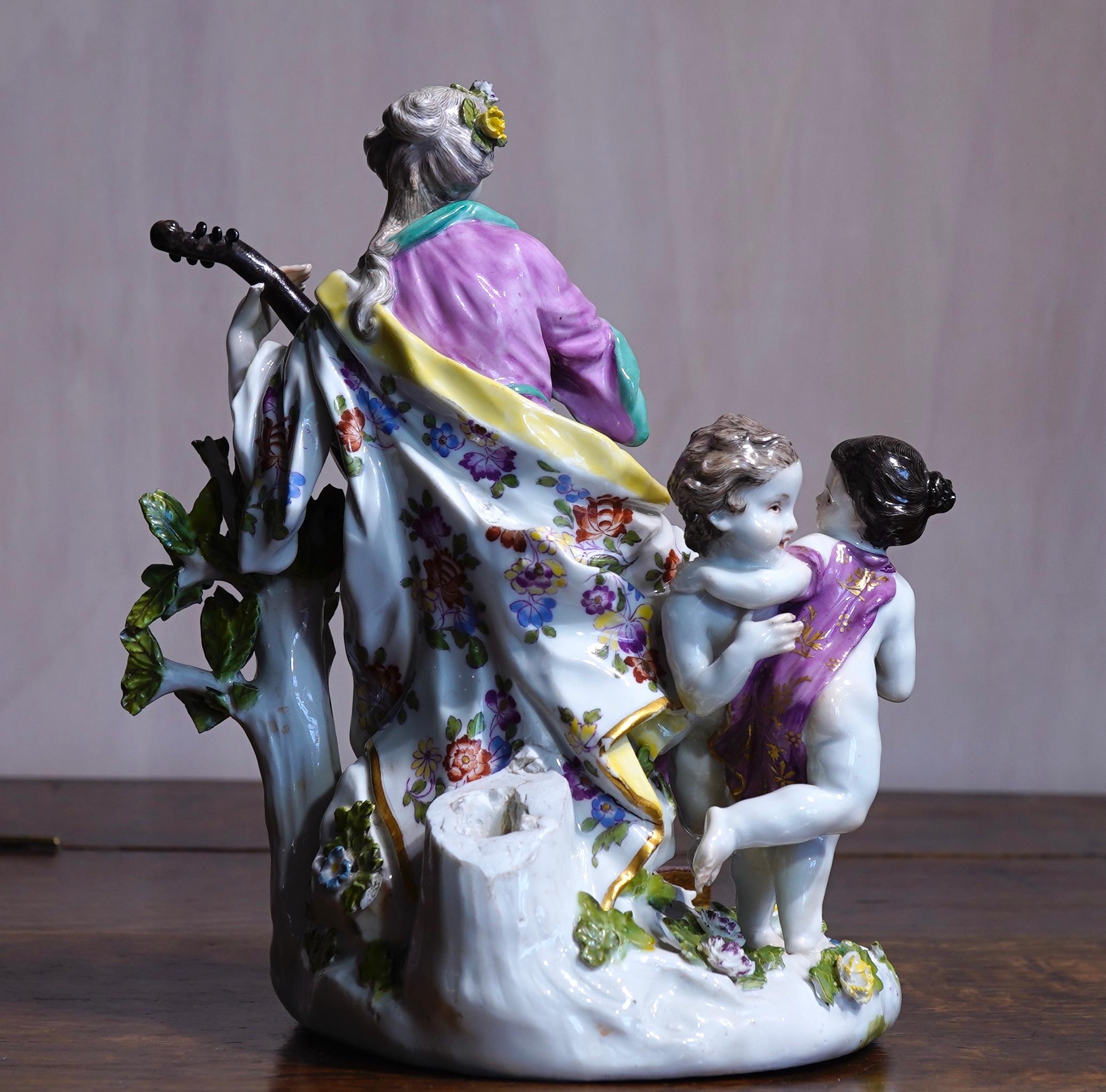 Meissen group of large size, depicting Terpsichore, the muse of dance and lyrical poetry, from a series of the nine Greek muses (the daughters of Zeus), depicted seated on a rocky outcrop playing a large lute, a book and bagpipes at her feet, a