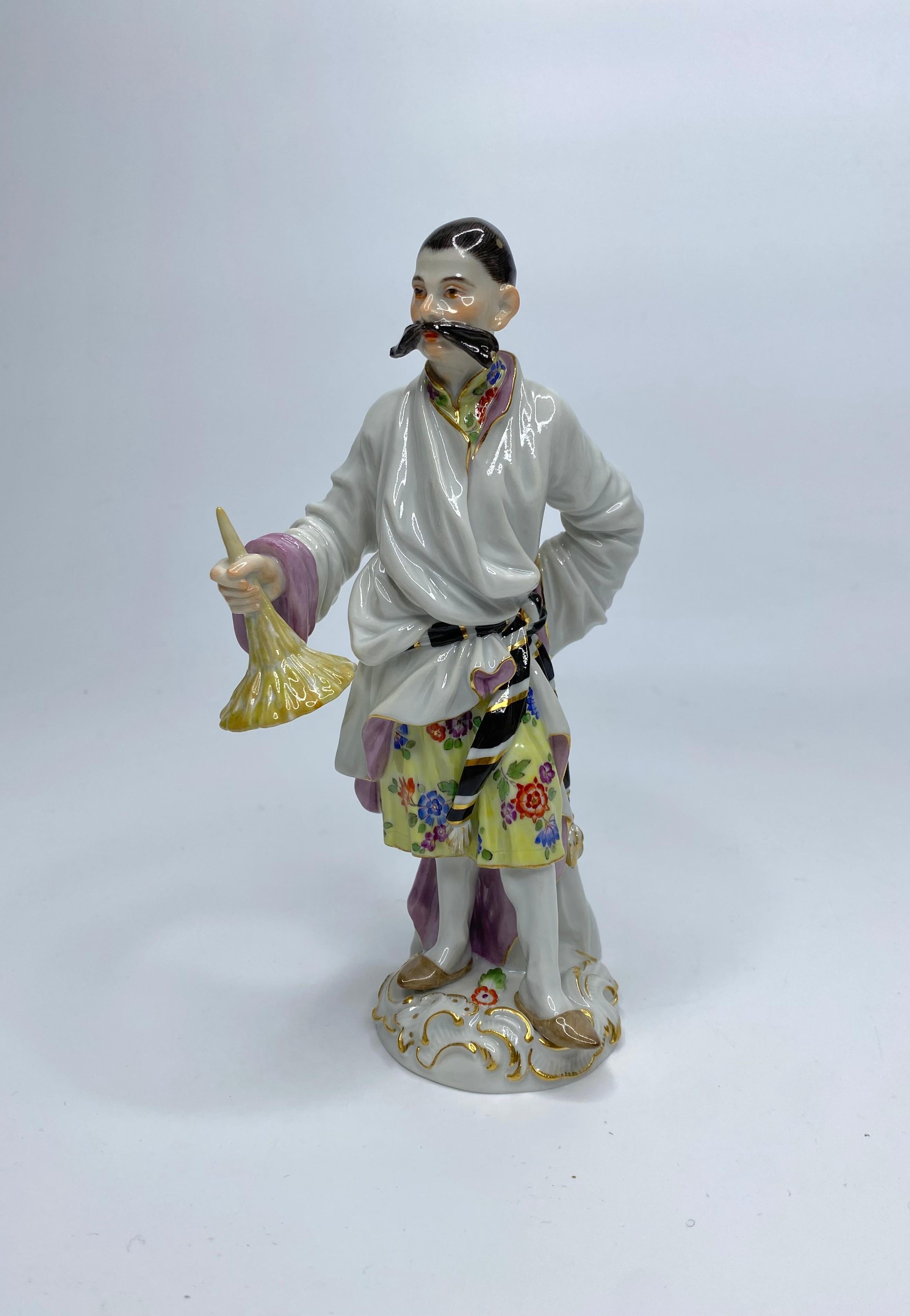 Pair Meissen porcelain figures, 20th Century. Modelled after J.J. Kaendler and P.Reineke, as the ‘Japanese Couple’. The lady, holding a parasol, and dressed elegantly, her dress painted in Indianische Blumen. The man with a magnificent moustache,