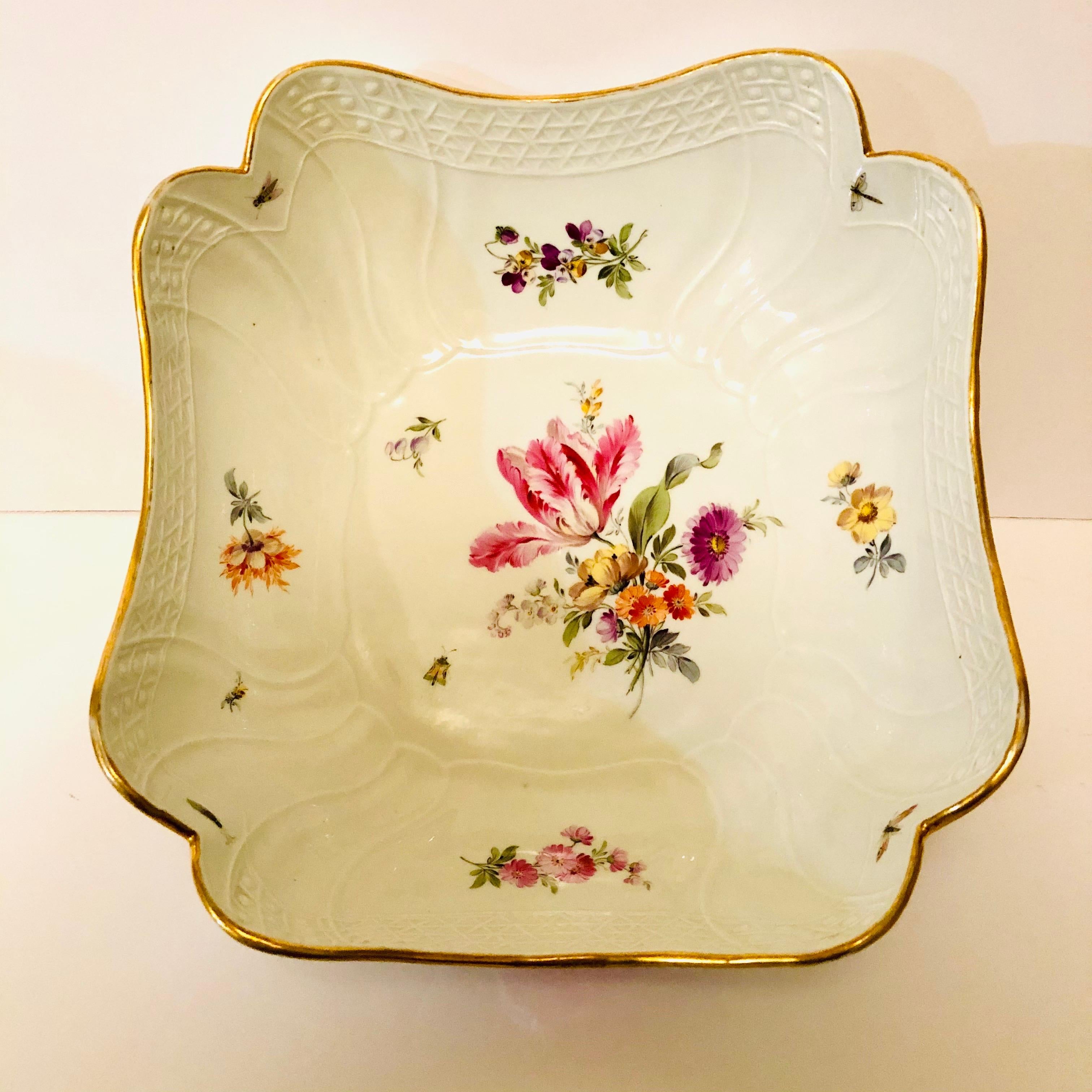 I want to offer you this beautifully painted Meissen four cornered deep serving bowl painted with a large tulip flower bouquet in the center and four different flower bouquets, one on each side of the bowl. It is also decorated with little insects
