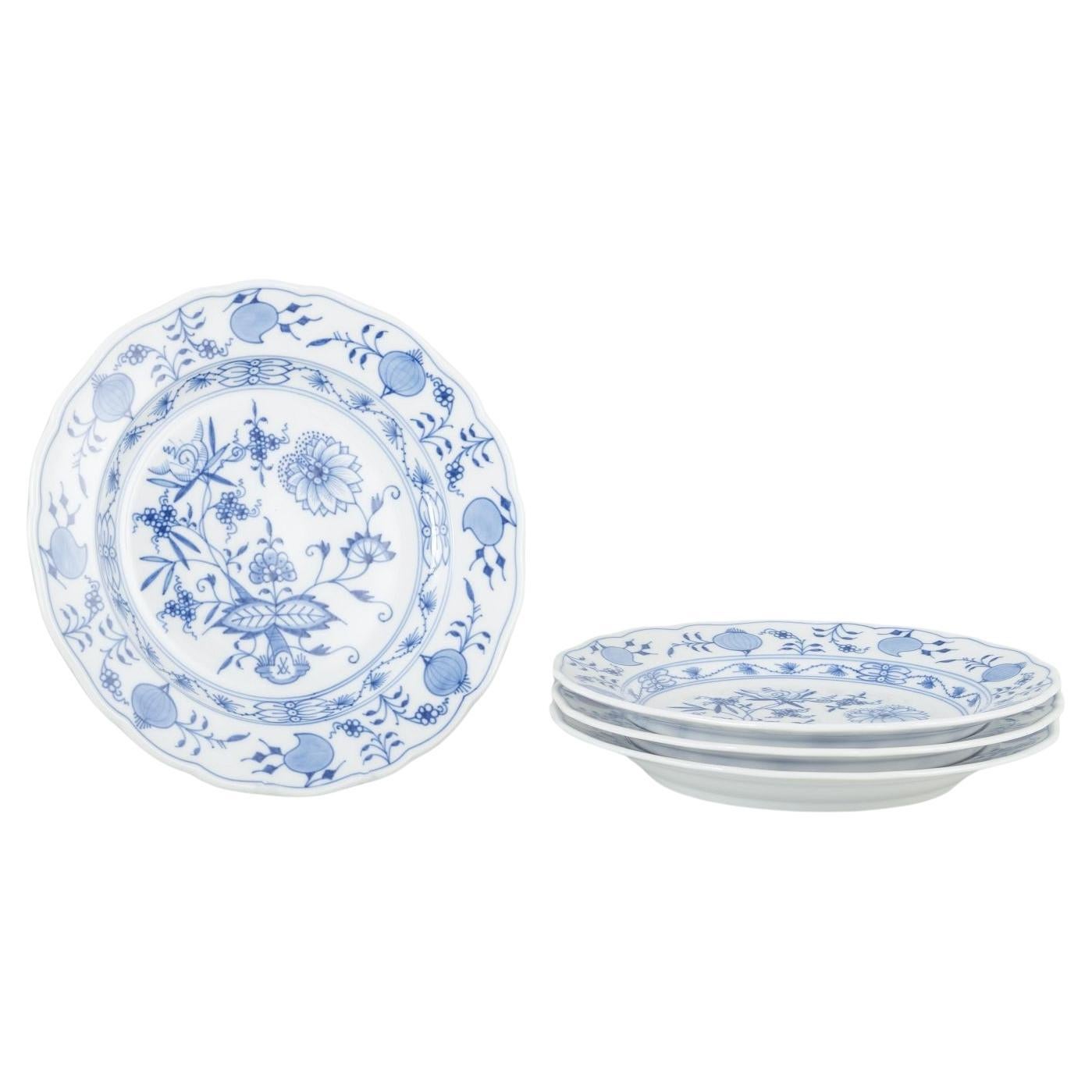 Meissen, Germany. 4 porcelain dinner plates with “Blue Onion” pattern.