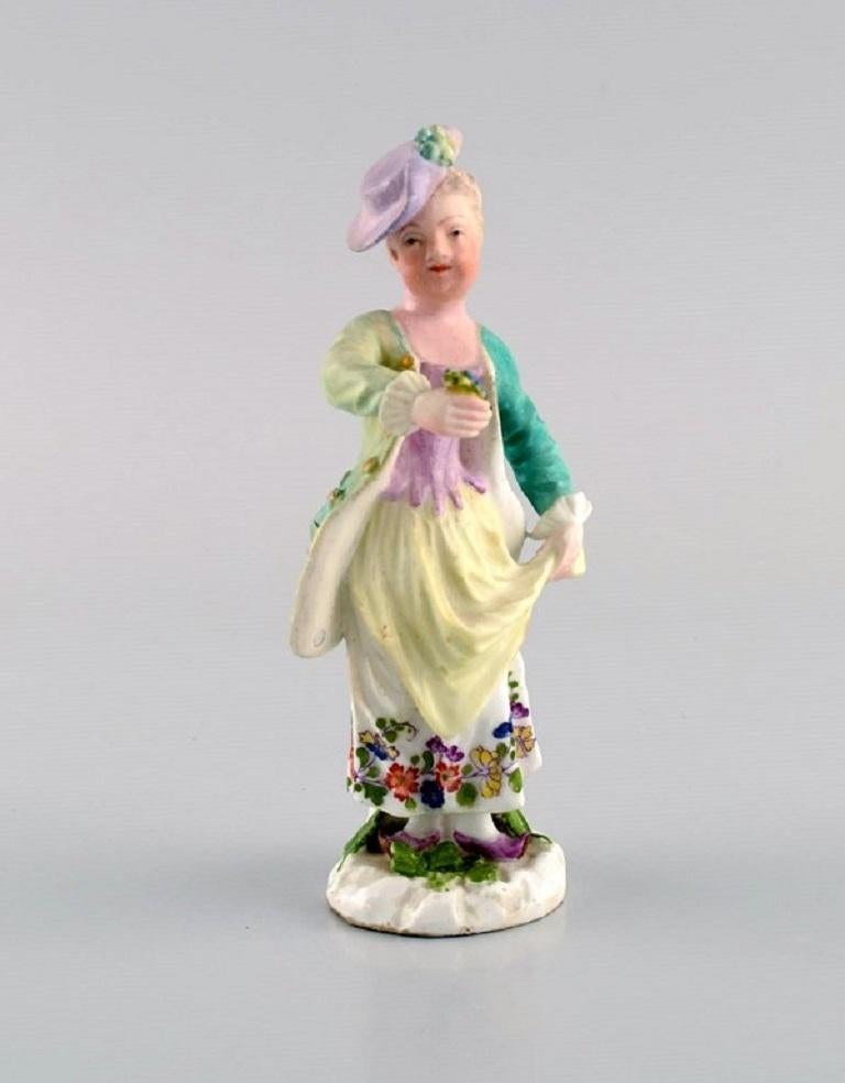 Meissen, Germany. Antique hand-painted porcelain figure. 
Lady with flowers. Late 19th century.
Measures: 12 x 5.5 cm.
In excellent condition. Minimal cut on a flower.
Stamped.