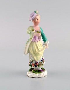 Meissen, Germany. Antique hand-painted porcelain figure. Lady with flowers.