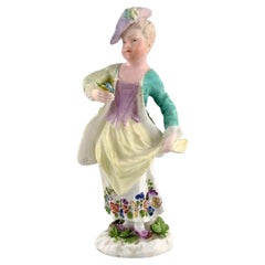 Meissen, Germany. Antique hand-painted porcelain figure. Lady with flowers. 