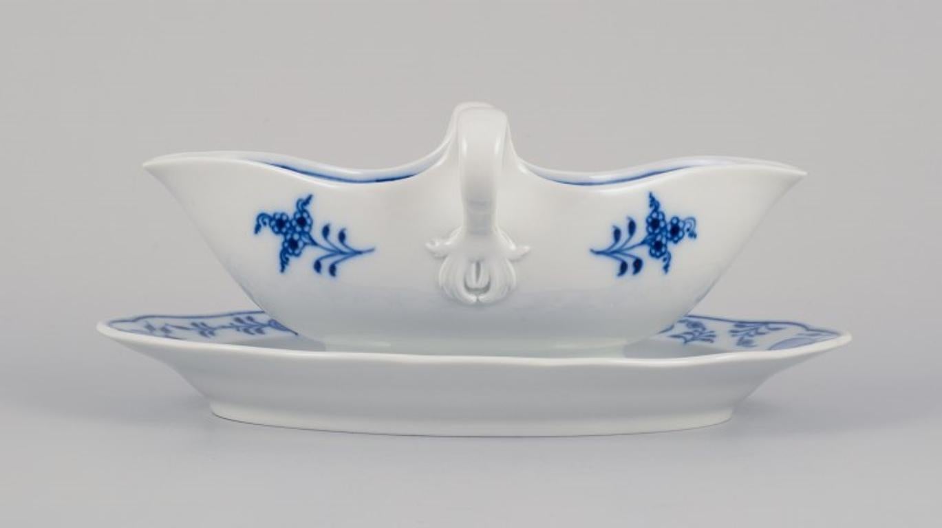 Meissen, Germany. Blue Onion pattern sauce boat with two handles. 
Hand-painted.
Approximately from the 1930s.
Marked.
First factory quality.
In perfect condition.
Dimensions: Length 24.0 cm x Width 14.0 cm x Height 9.8 cm.

