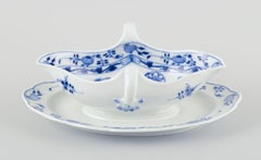 Meissen, Germany. Blue Onion porcelain gravy boat with two handles on a foot.