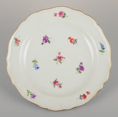 Meissen, Germany. Five porcelain plates with floral motifs and gold rims