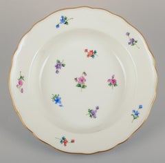 Meissen, Germany. Four deep plates in porcelain. Hand-painted with flowers