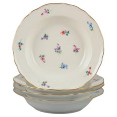 Meissen, Germany. Four deep plates in porcelain with floral motifs.