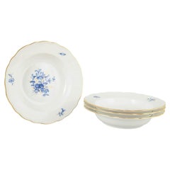 Meissen, Germany. Four deep porcelain plates with floral motifs. Early 20th C.
