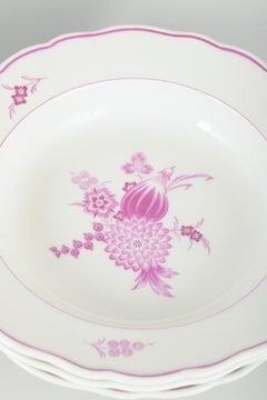 Meissen, Germany. Four deep porcelain plates with floral motifs in purple/pink