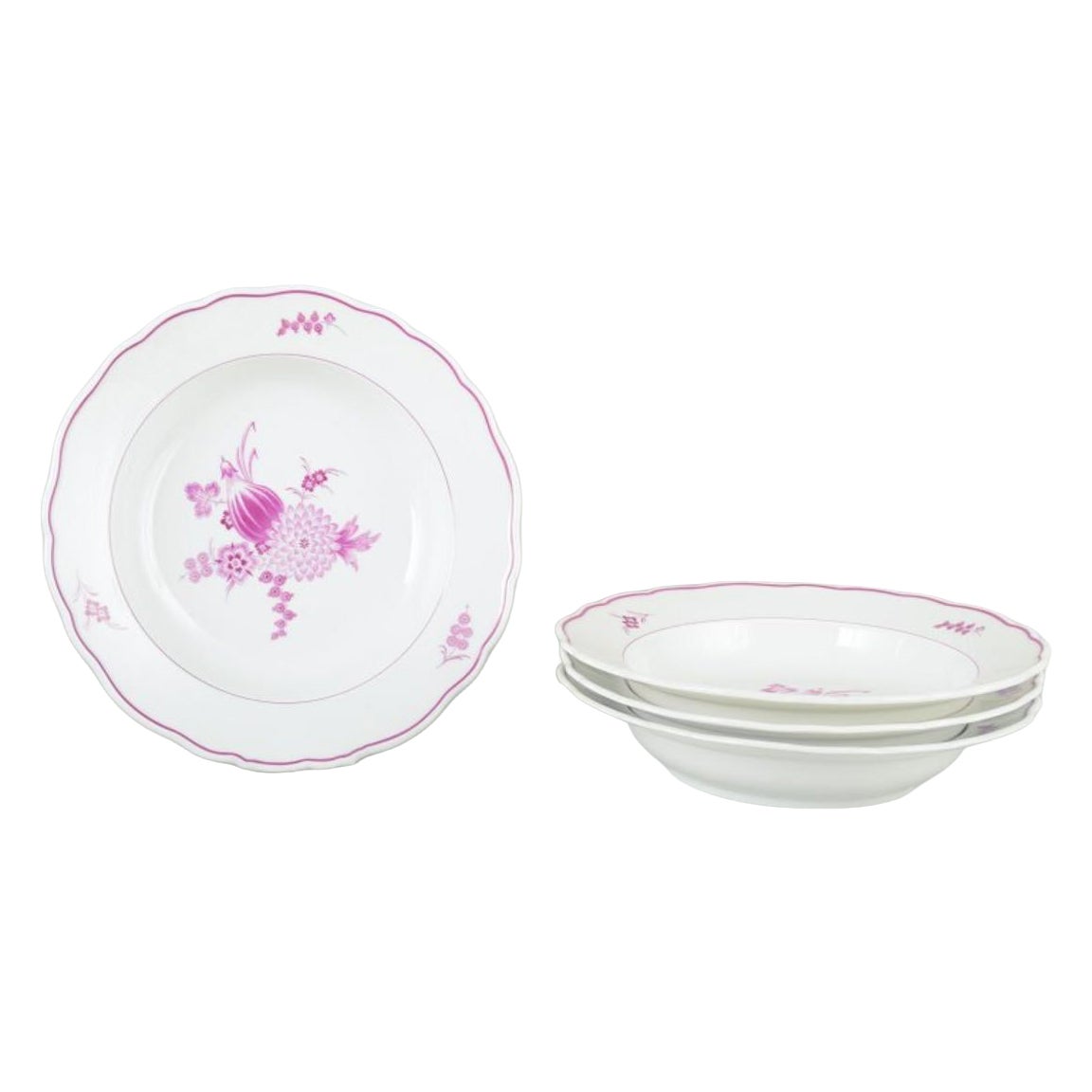 Meissen, Germany. Four deep porcelain plates with floral motifs in purple/pink
