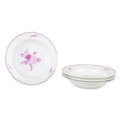 Meissen, Germany. Four deep porcelain plates with floral motifs in purple/pink