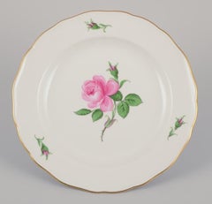Meissen, Germany. Four dinner plates with a motif of a pink rose.