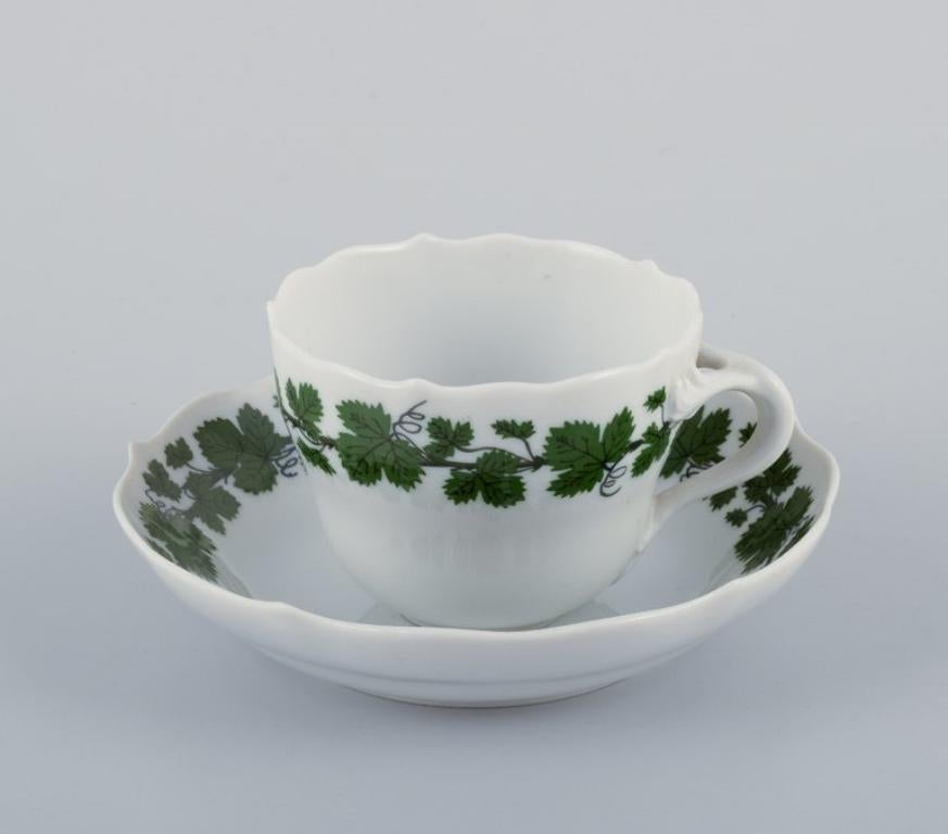 Meissen, Germany, Green Ivy Vine, a set of five demitasse cups with matching saucers. Hand-painted.
Mid-20th century.
Marked.
One cup and saucer in first factory quality. Four cups and saucers in third factory quality.
In perfect condition.
Cup: