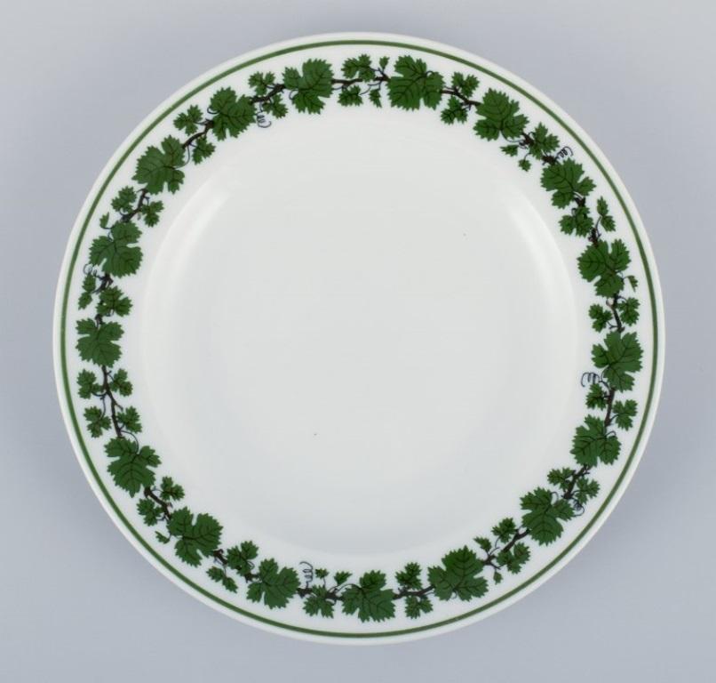 Meissen, Germany, Green Ivy Vine, seven plates in three different sizes. 
Hand-painted.
1930s/1940s.
Marked.
First factory quality. Two plates in third factory quality.
Perfect condition.
Dimensions: From D 17.0 cm - D 19.6 cm.