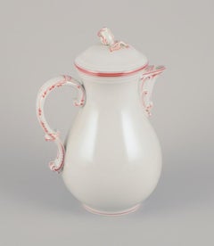 Meissen, Germany. Large coffee pot decorated with coral red trim.
