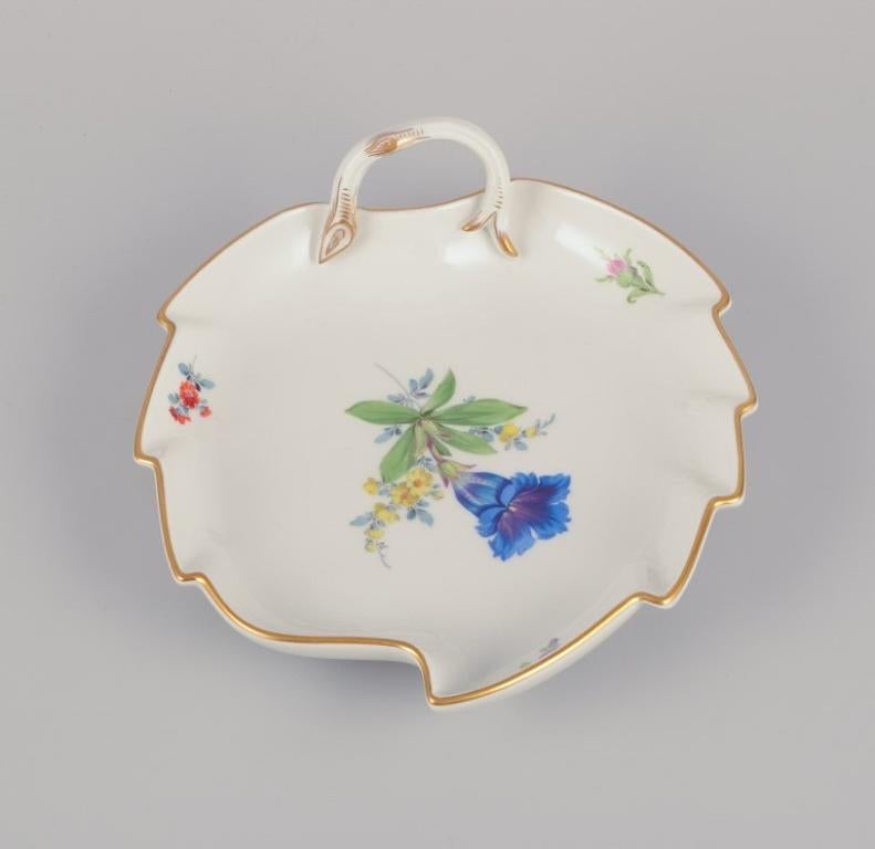 Meissen, Germany. Leaf-shaped porcelain dish. 
Hand-painted with polychrome flower motifs.
From the 1930s.
Marked.
First factory quality.
In perfect condition.
Dimensions: Length 19.0 cm x Width 16.5 cm x Height 5.5 cm.