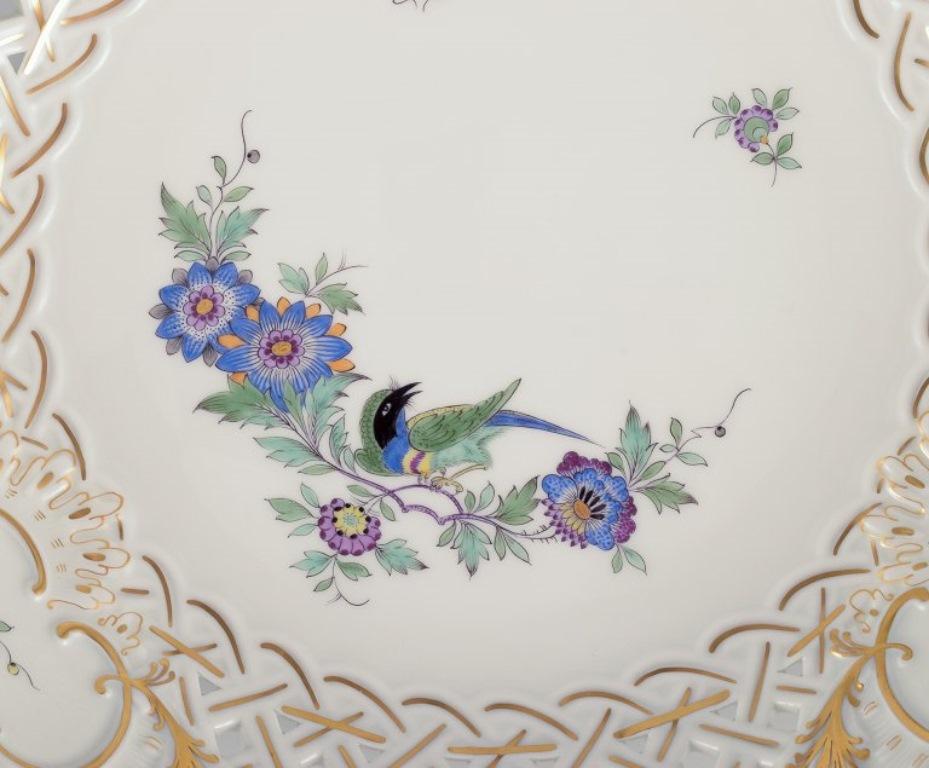 20th Century Meissen, Germany. Open lace bowl in porcelain, decorated with exotic bird. For Sale