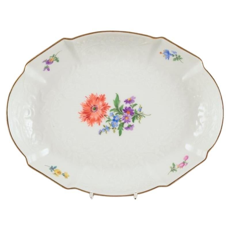 Meissen, Germany. Oval porcelain bowl hand-painted with polychrome flowers. 