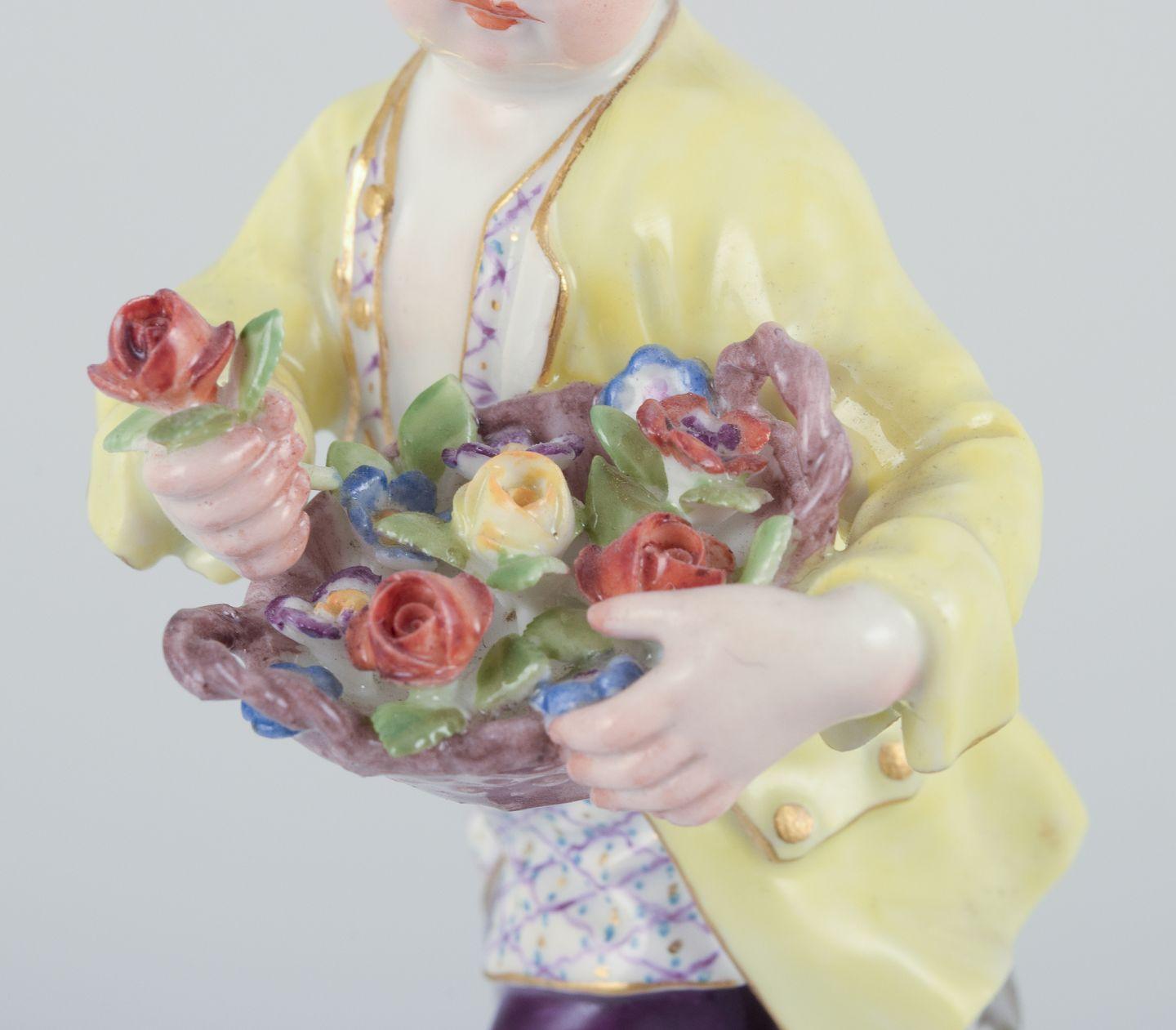 Rococo Revival Meissen, Germany. Porcelain figurine of boy with basket of flowers. Ca 1900 For Sale