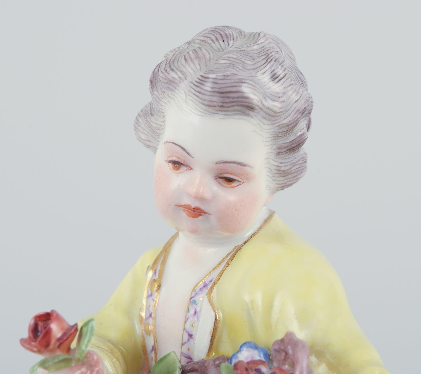 Hand-Painted Meissen, Germany. Porcelain figurine of boy with basket of flowers. Ca 1900 For Sale