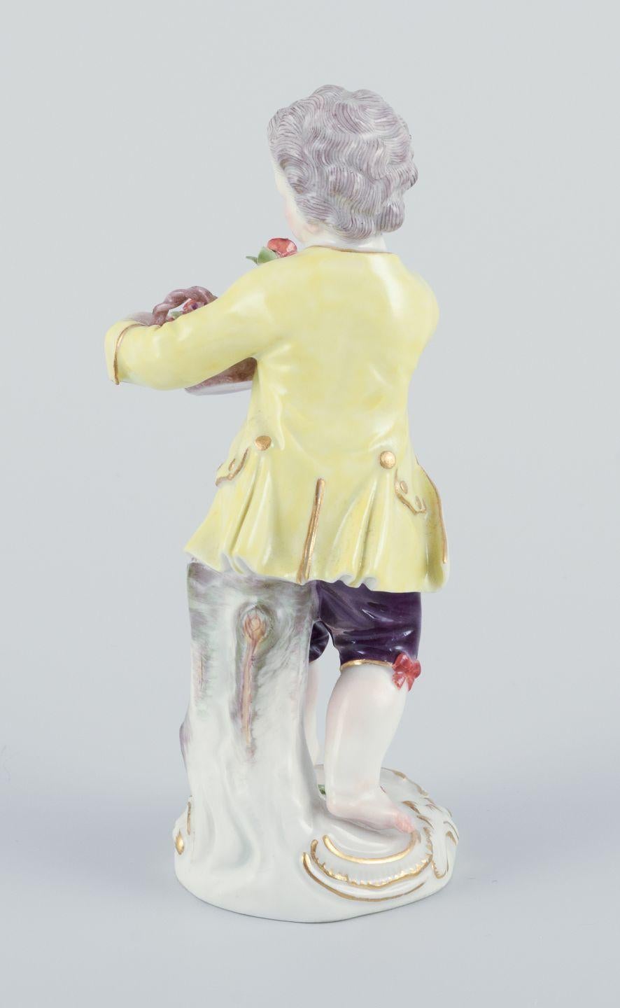 20th Century Meissen, Germany. Porcelain figurine of boy with basket of flowers. Ca 1900 For Sale