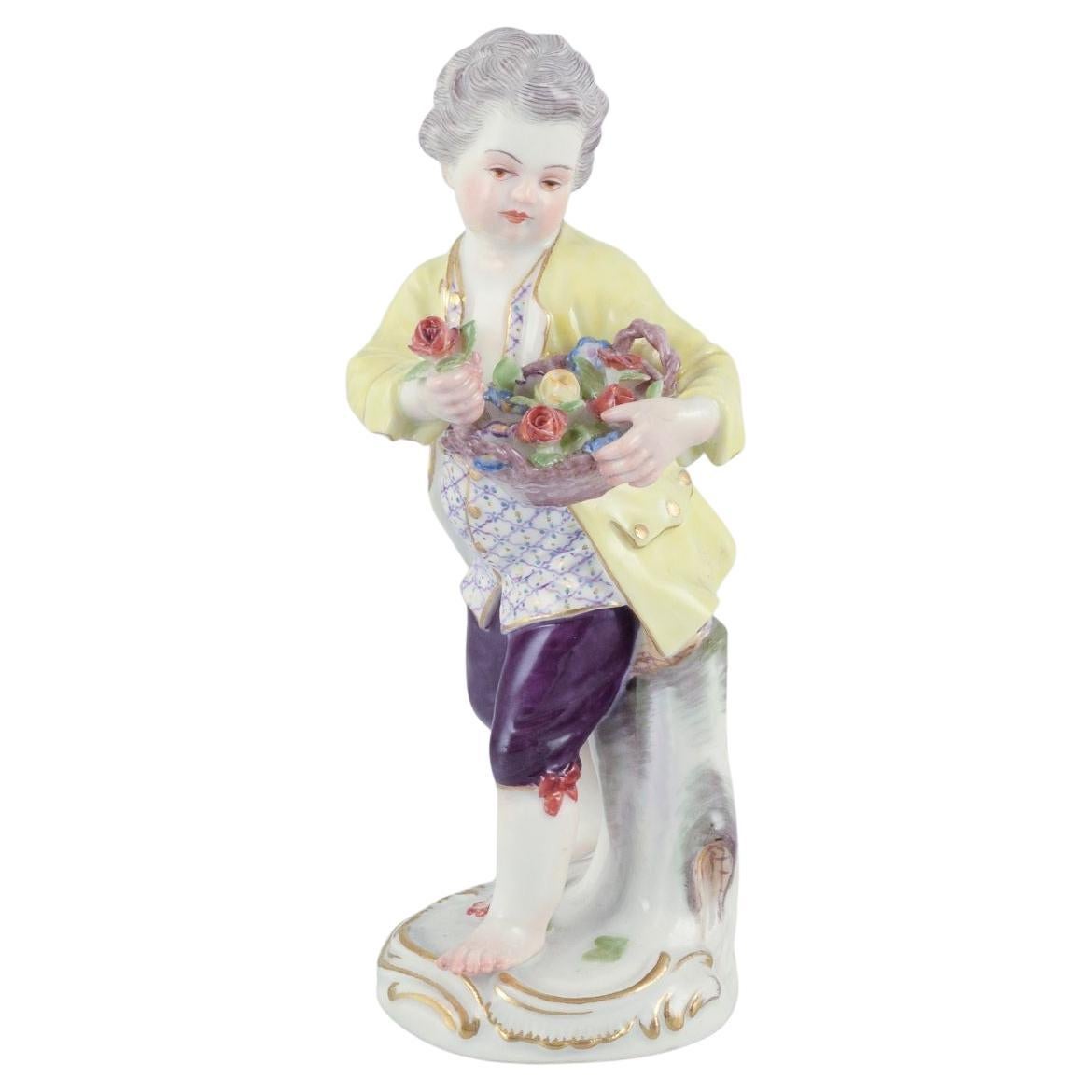 Meissen, Germany. Porcelain figurine of boy with basket of flowers. Ca 1900