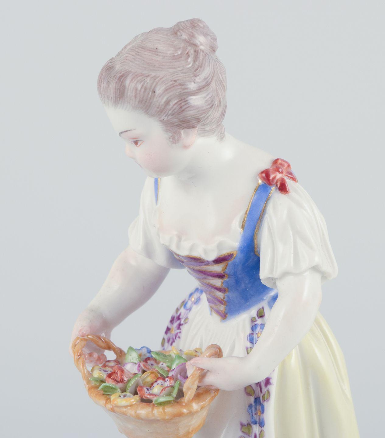 Hand-Painted Meissen, Germany. Porcelain figurine of girl with basket. Ca 1900 For Sale