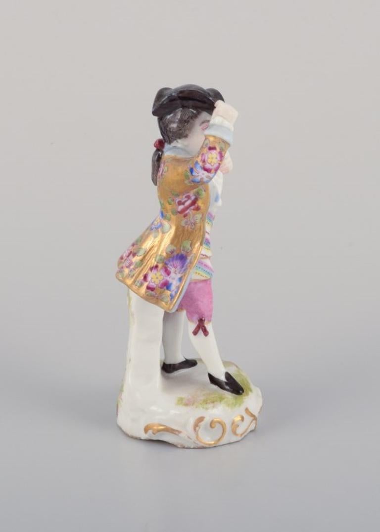 Meissen, Germany. Porcelain figurine of young man in elegant attire. In Excellent Condition For Sale In Copenhagen, DK