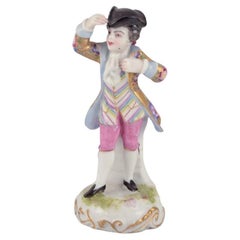 Antique Meissen, Germany. Porcelain figurine of young man in elegant attire.